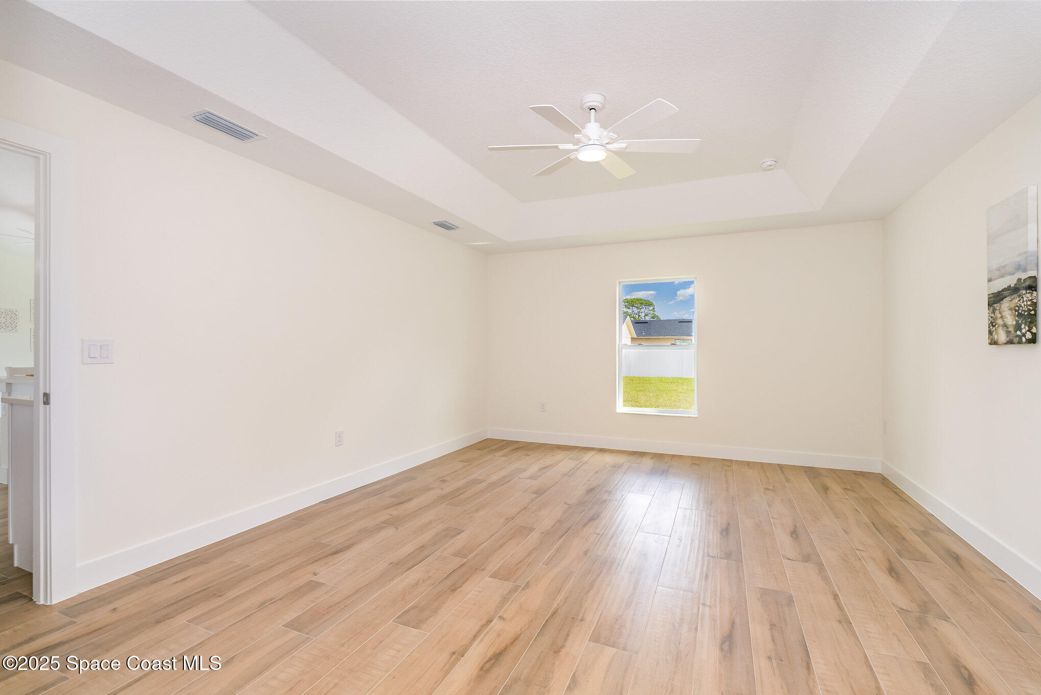 6003 Gilson Avenue Cocoa, FL 32927 - Photo 13 of 27 an empty room with wooden floor closet and windows