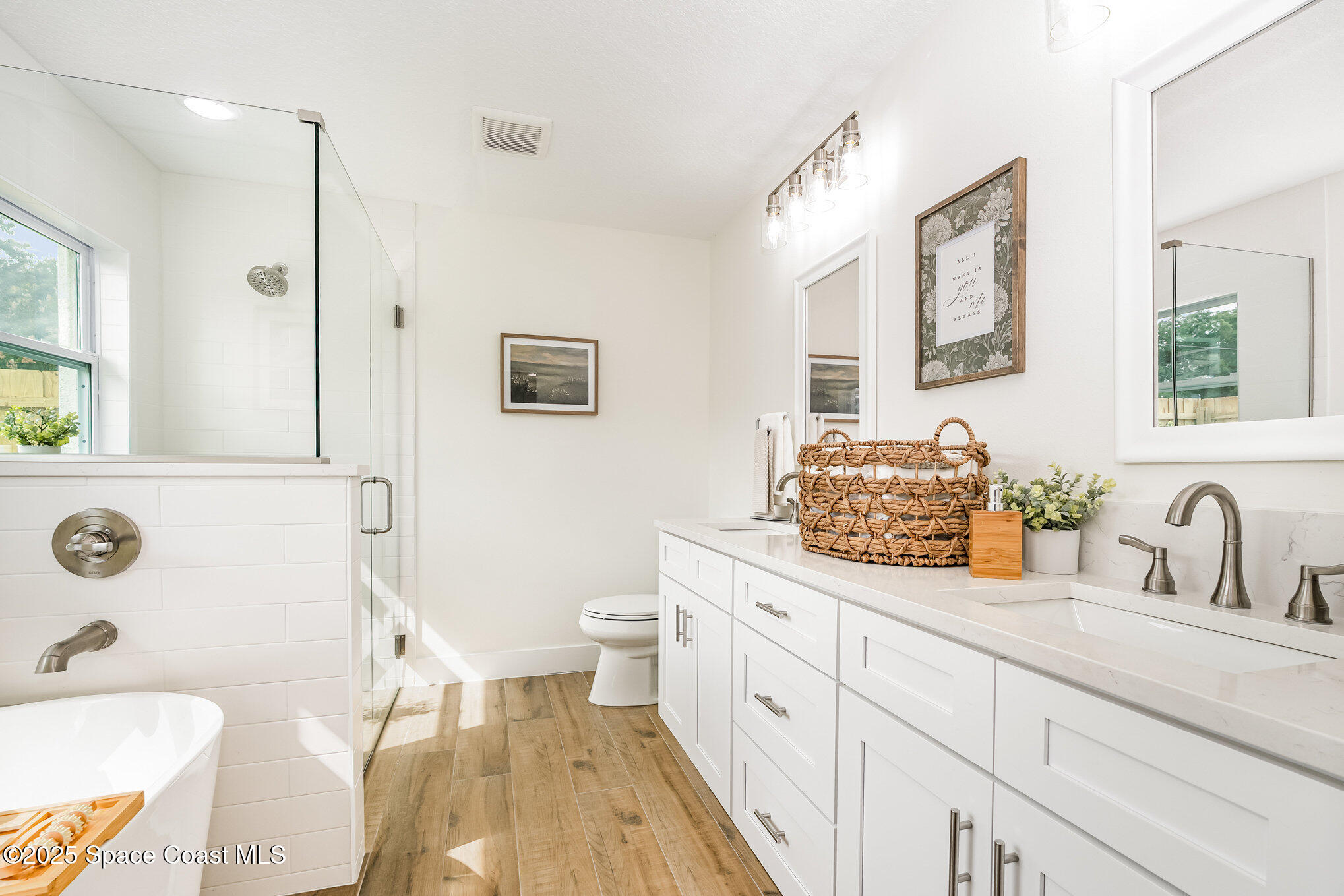 6003 Gilson Avenue Cocoa, FL 32927 - Photo 17 of 27 a bathroom with a granite countertop sink mirror vanity and toilet