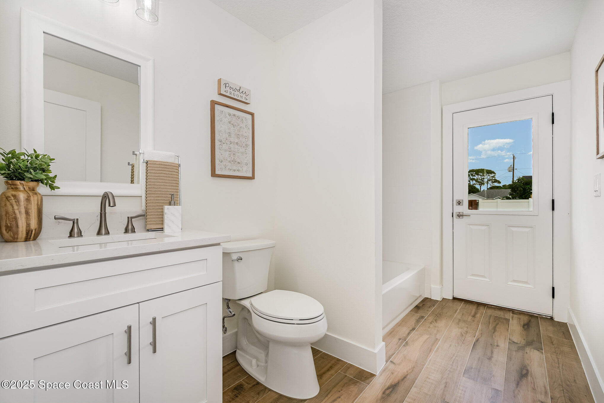6003 Gilson Avenue Cocoa, FL 32927 - Photo 21 of 27 a bathroom with a toilet a sink and mirror