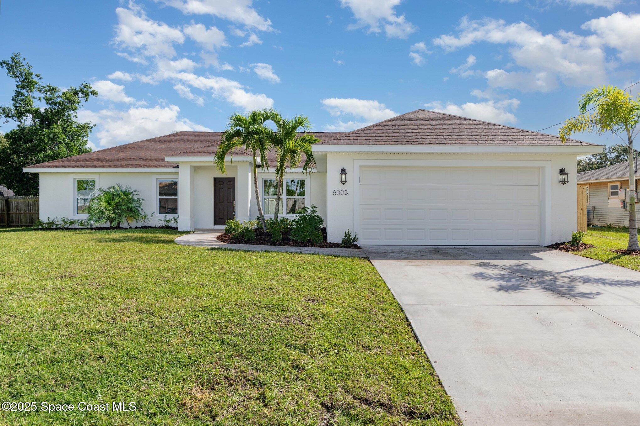 6003 Gilson Avenue Cocoa, FL 32927 - Photo 3 of 27 a front view of a house with garden