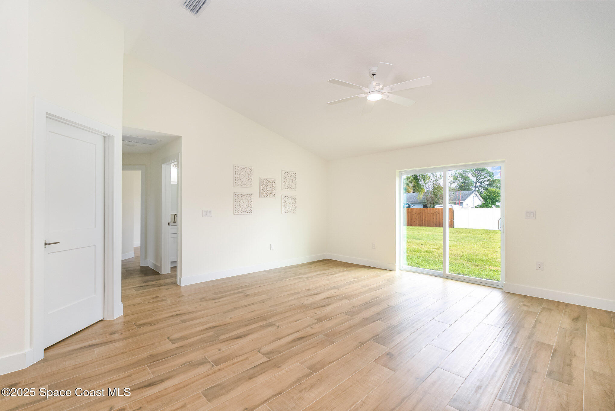 6003 Gilson Avenue Cocoa, FL 32927 - Photo 5 of 27 an empty room with wooden floor and windows