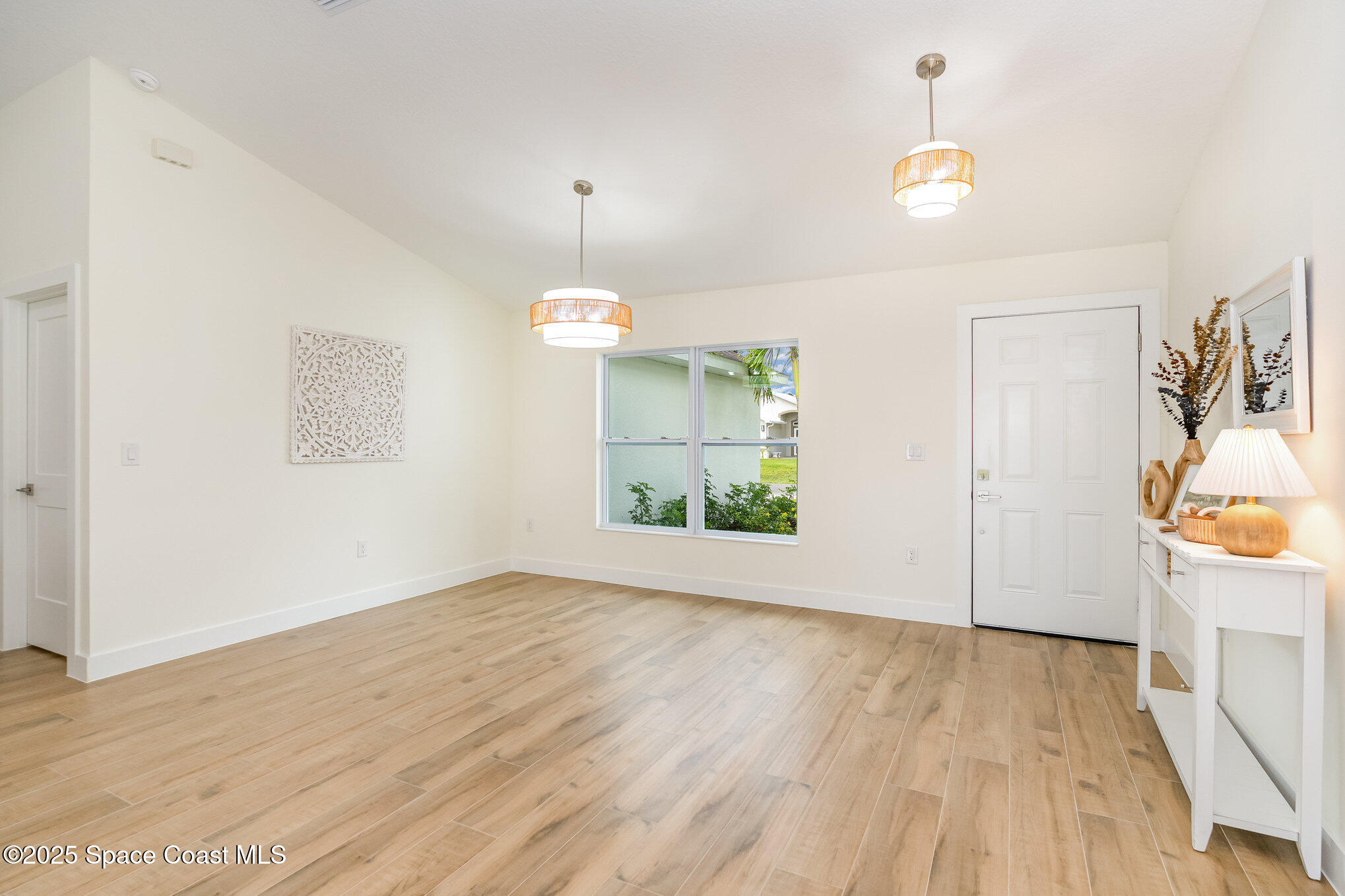 6003 Gilson Avenue Cocoa, FL 32927 - Photo 6 of 27 wooden floor in an empty room with a window