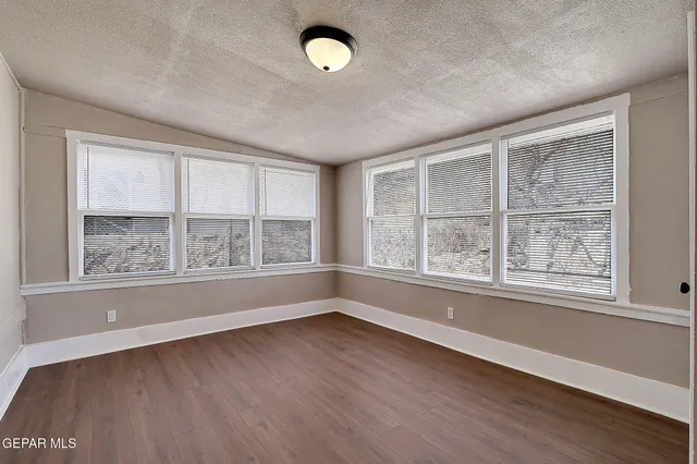 a view of a backyard with wooden fence