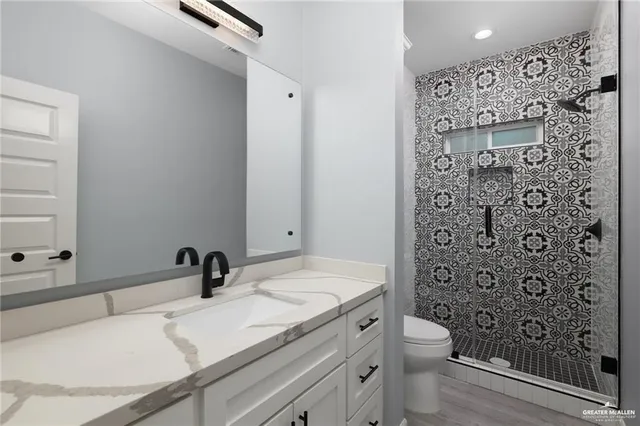 a bathroom with a sink toilet and shower