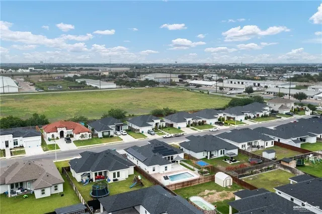 an aerial view of a houses with outdoor space swimming pool and ocean view
