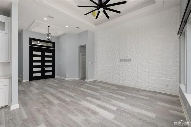 a view of a livingroom with a ceiling fan and window