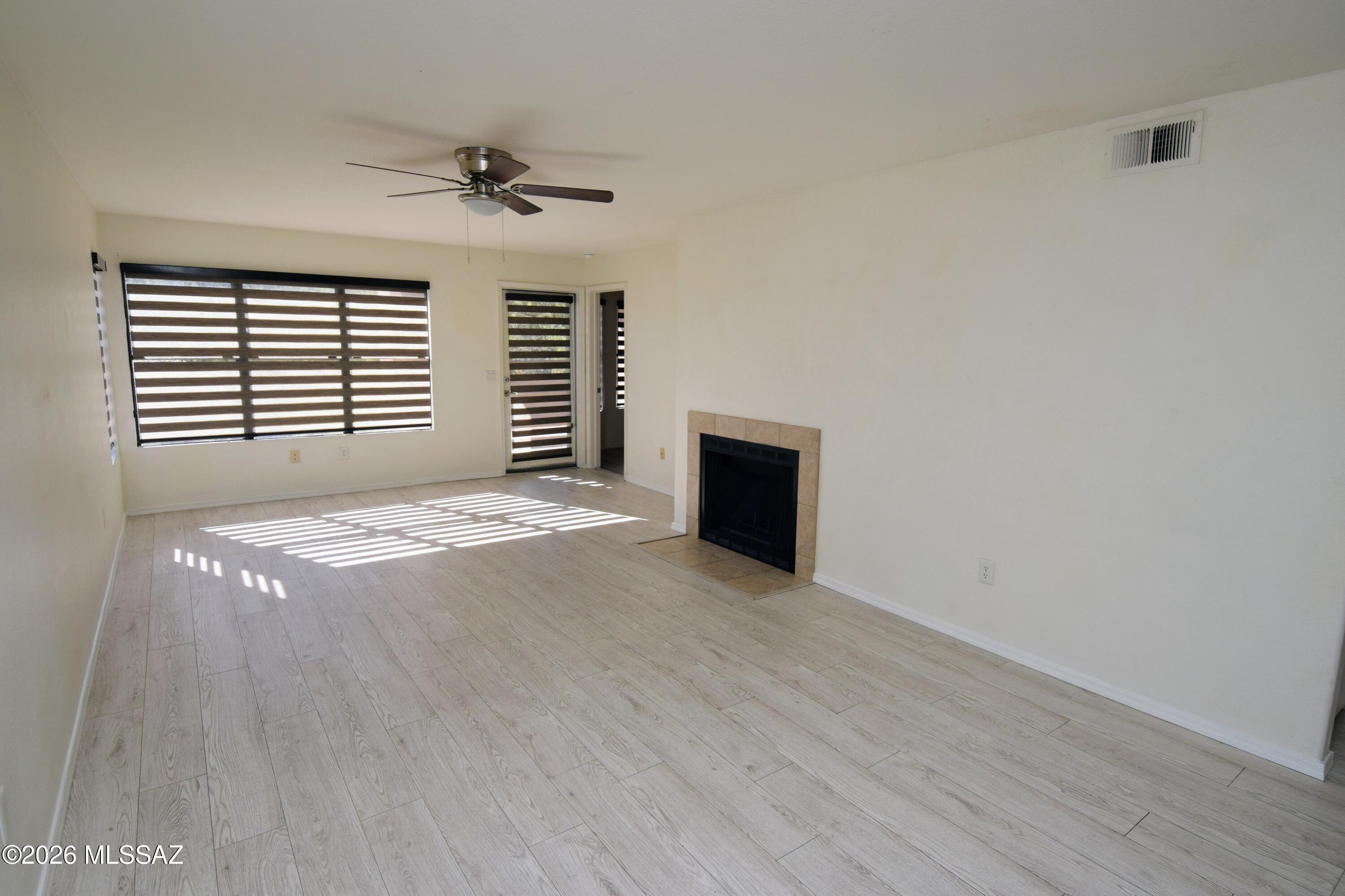 5855 North Kolb Road, Unit 11106 Tucson, AZ 85750 - Photo 2 of 36 a view of an empty room with a fireplace and a window