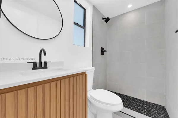 a bathroom with a toilet a sink and a mirror