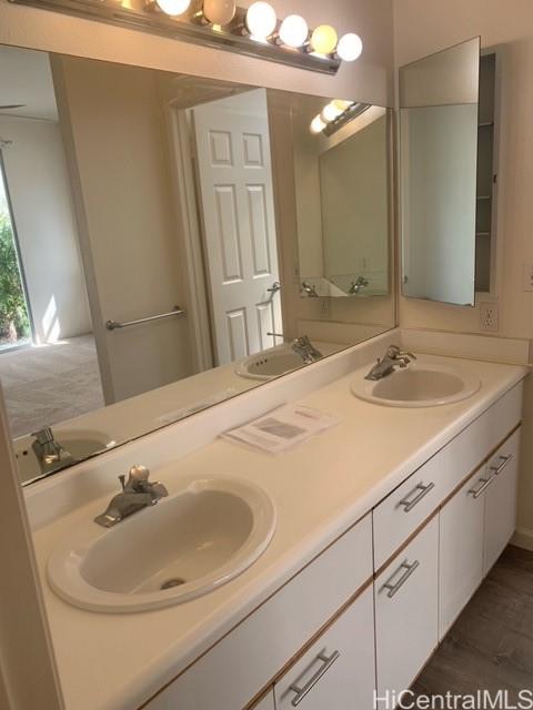 91-211 Kakuhihewa Place, Unit F Kapolei, HI 96707 - Photo 13 of 25 a bathroom with a sink and a mirror