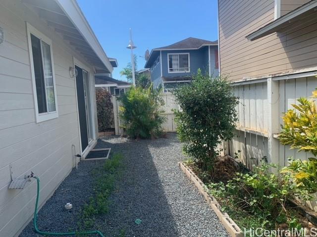 91-211 Kakuhihewa Place, Unit F Kapolei, HI 96707 - Photo 14 of 25 a front view of a house with garden