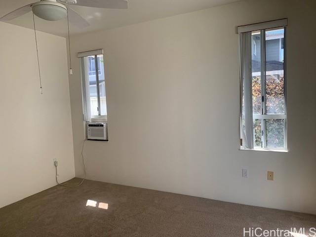 91-211 Kakuhihewa Place, Unit F Kapolei, HI 96707 - Photo 22 of 25 a view of an empty room with chandelier and window