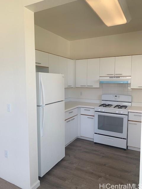 91-211 Kakuhihewa Place, Unit F Kapolei, HI 96707 - Photo 3 of 25 a kitchen with a refrigerator stove and white cabinets