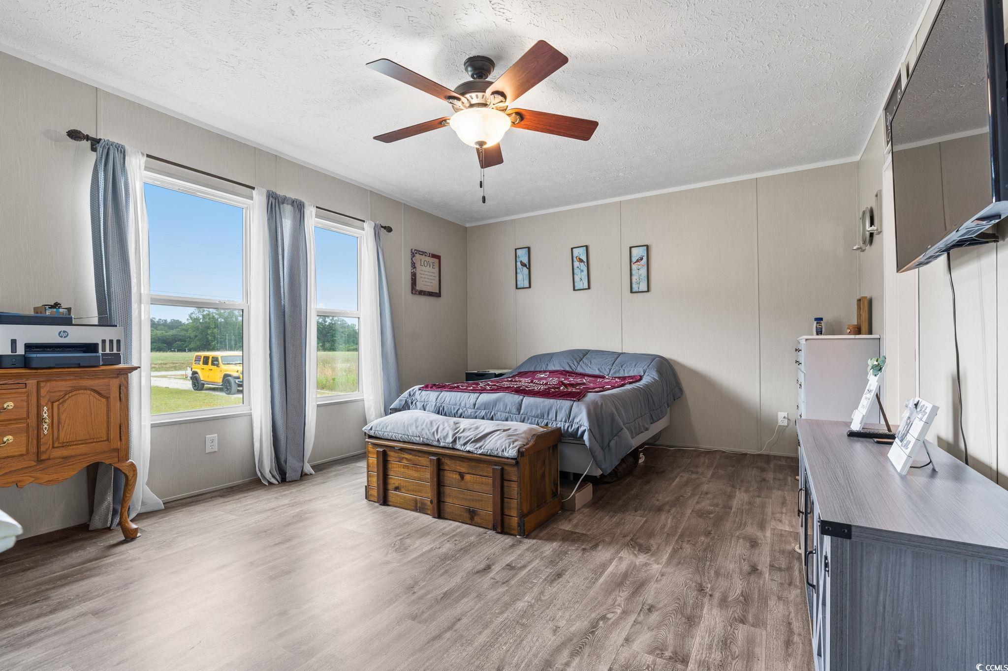 167 Dove Road Loris, SC 29569 - Photo 15 of 40 Bedroom with wood finished floors, a textured ceil