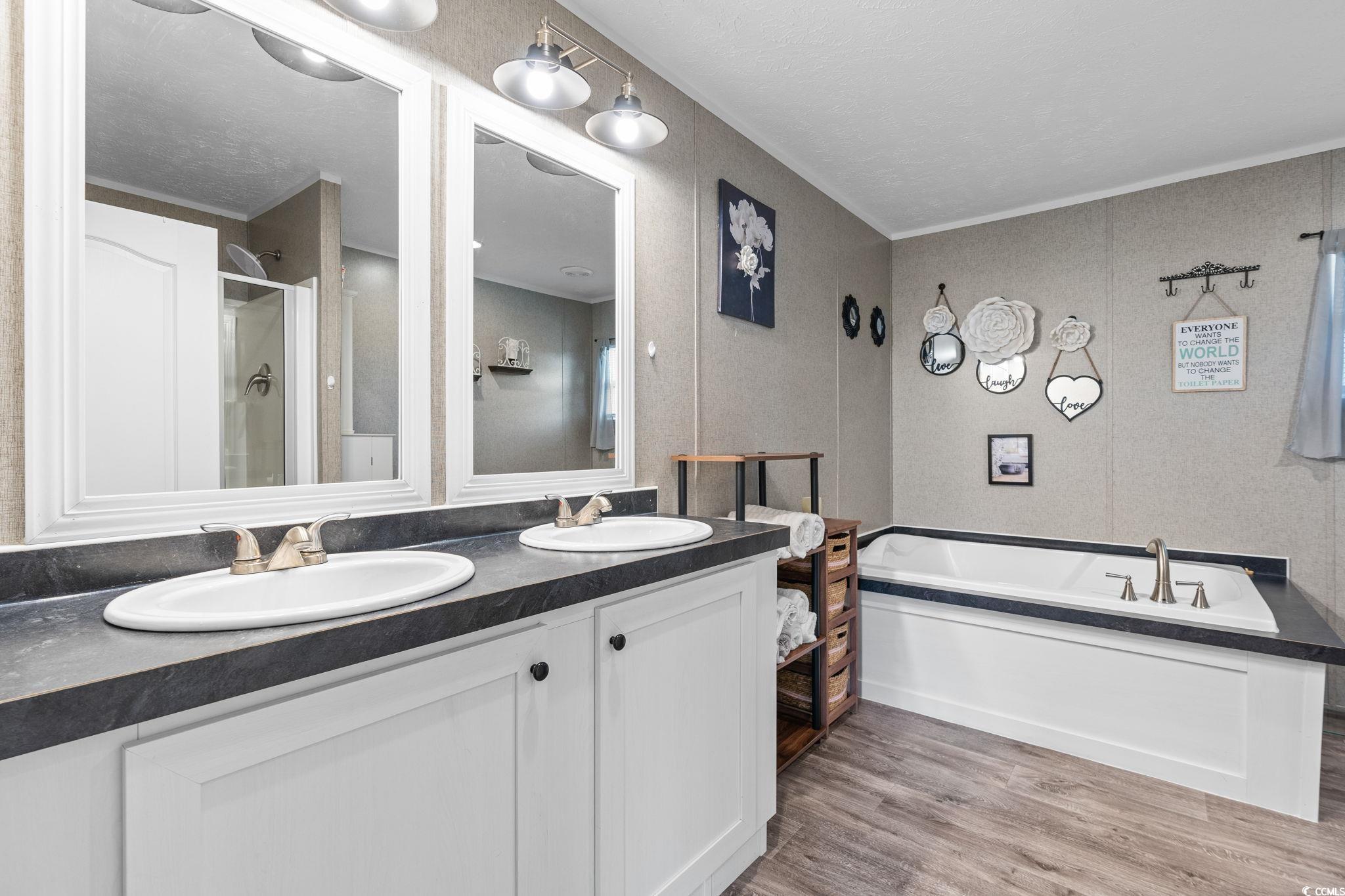 167 Dove Road Loris, SC 29569 - Photo 17 of 40 Full bath featuring double vanity, a bath, wood fi