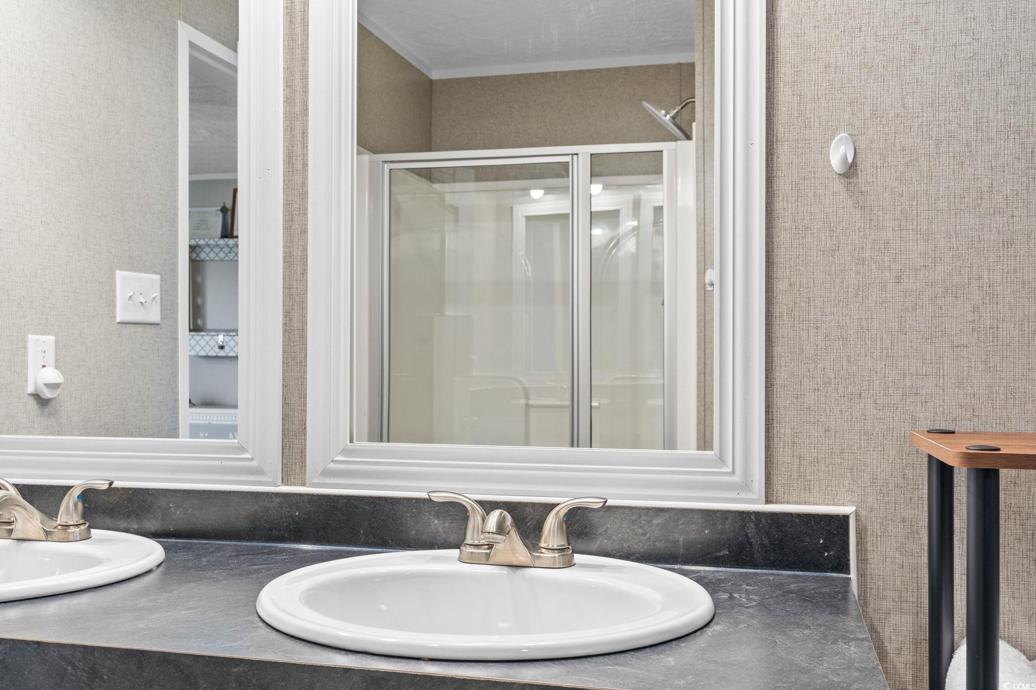 167 Dove Road Loris, SC 29569 - Photo 19 of 40 Bathroom with double vanity and a stall shower