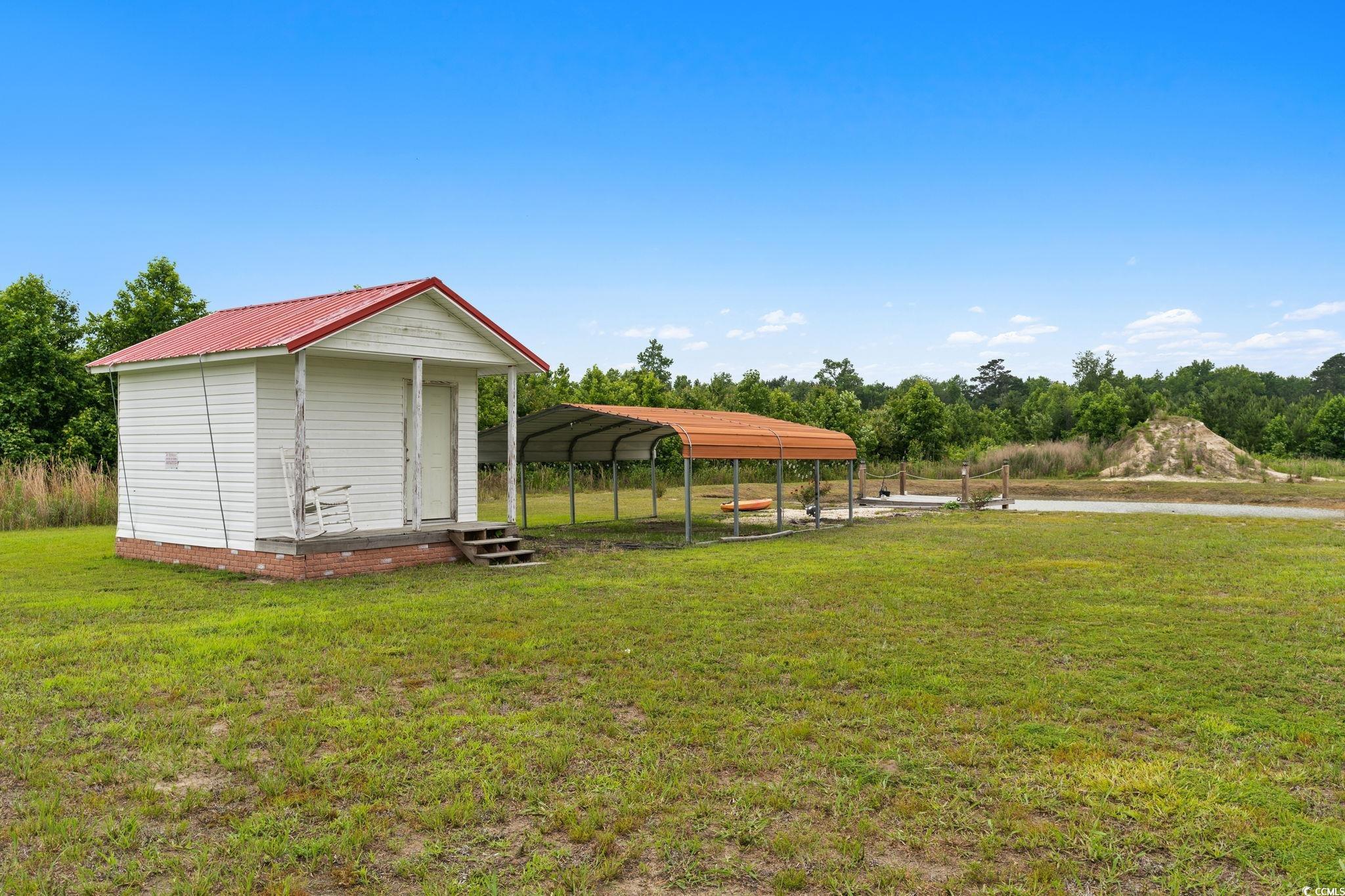 167 Dove Road Loris, SC 29569 - Photo 29 of 40 View of green lawn featuring a detached carport