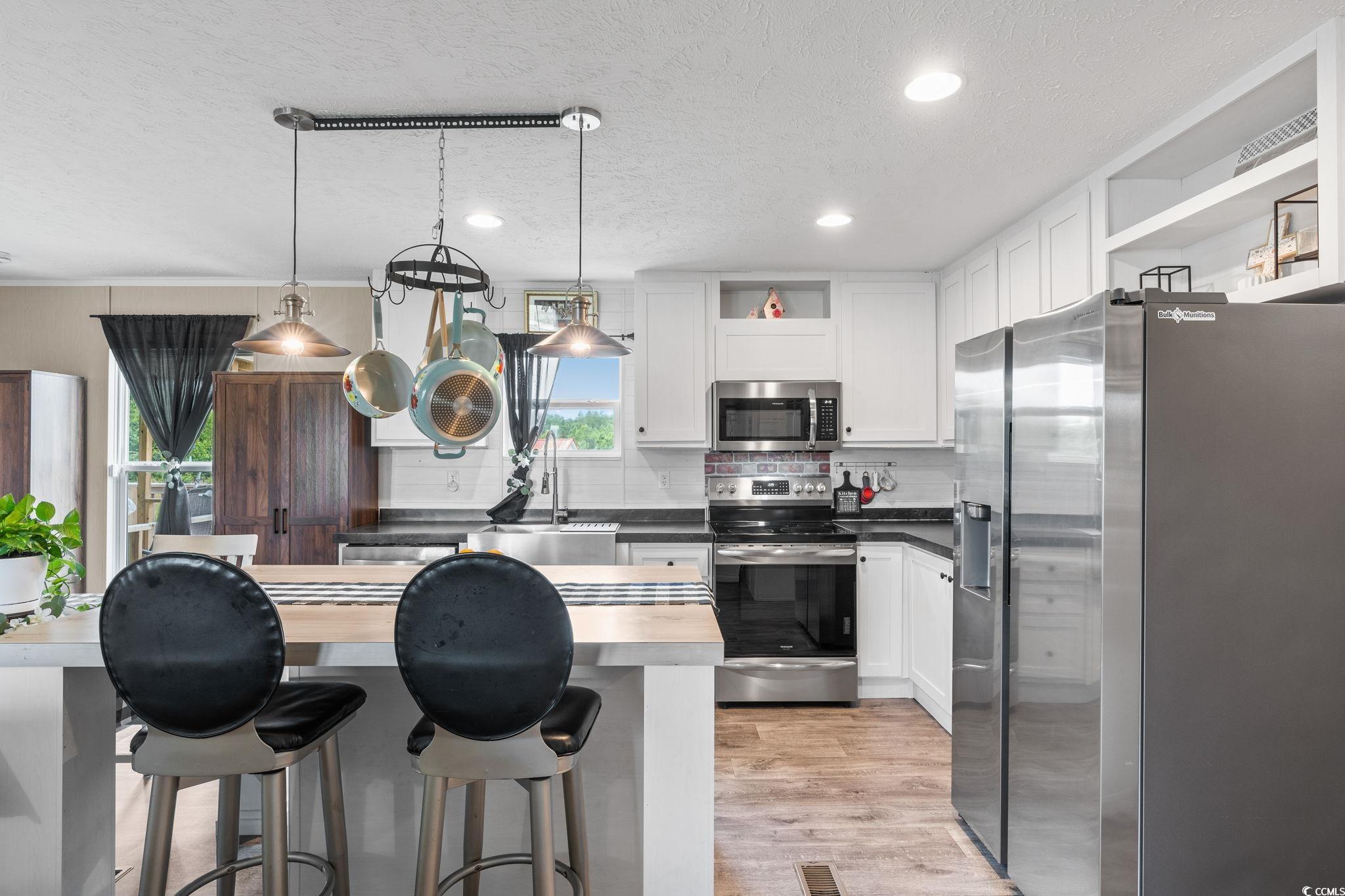 167 Dove Road Loris, SC 29569 - Photo 10 of 40 Kitchen with stainless steel appliances, open shel