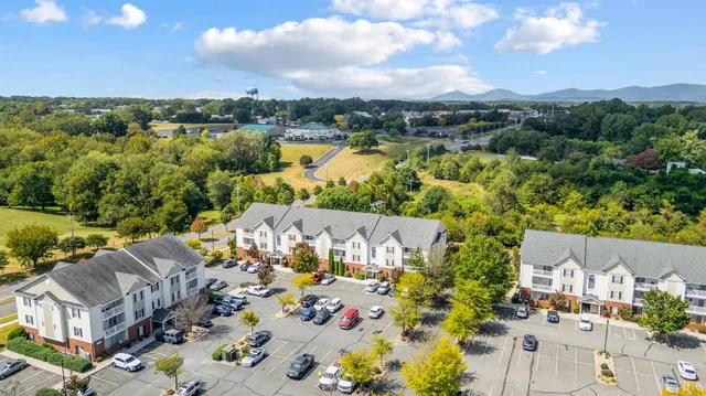an aerial view of residential building with green space