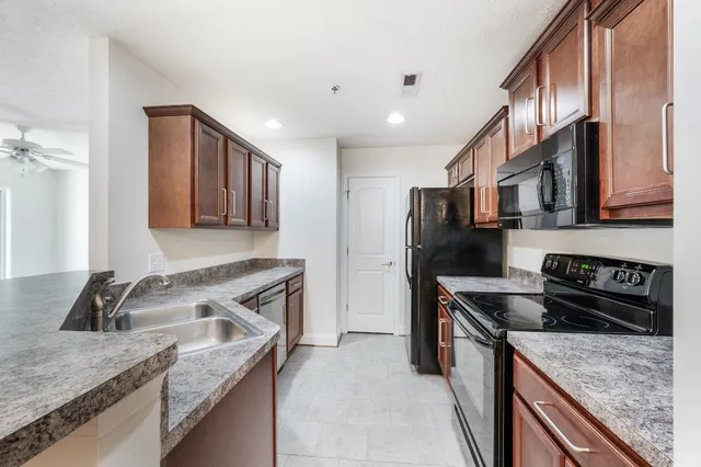 a kitchen that has a sink and a stove