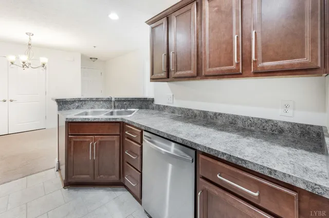a kitchen with granite countertop cabinets sink and stove