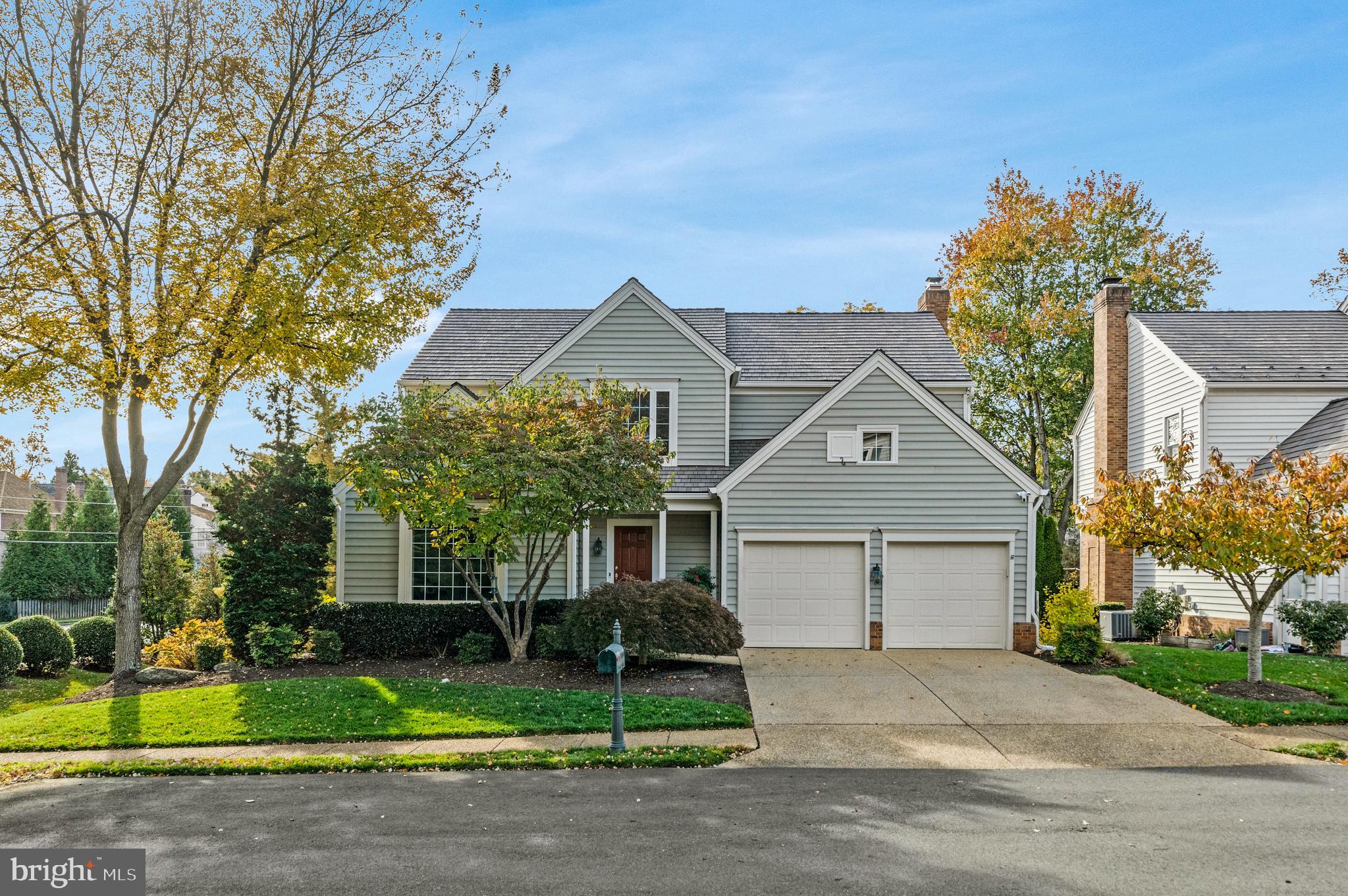 9733 Hidden Valley Road Vienna, VA 22181 - Photo 2 of 11 a front view of a house with a yard and garage