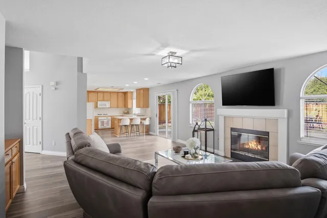 a living room with furniture fireplace and flat screen tv