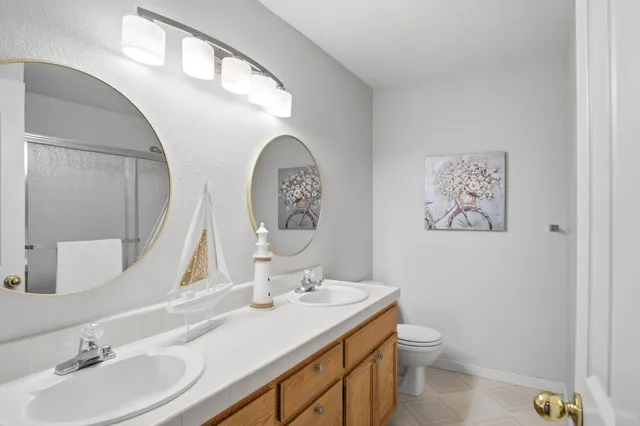 a bathroom with a toilet a sink and a mirror