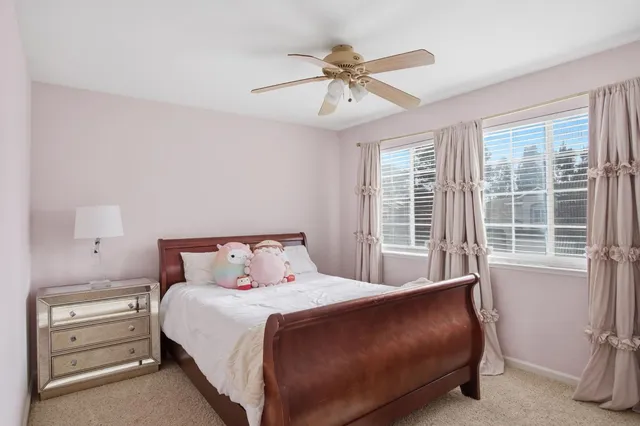 a bedroom with a bed and window