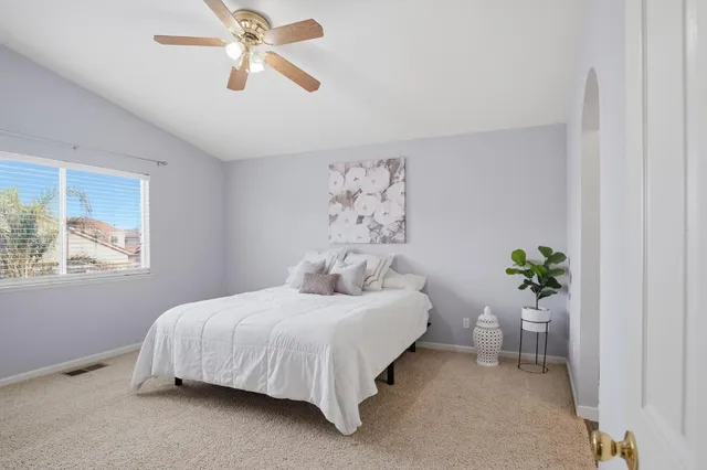 a bedroom with a bed and ceiling fan