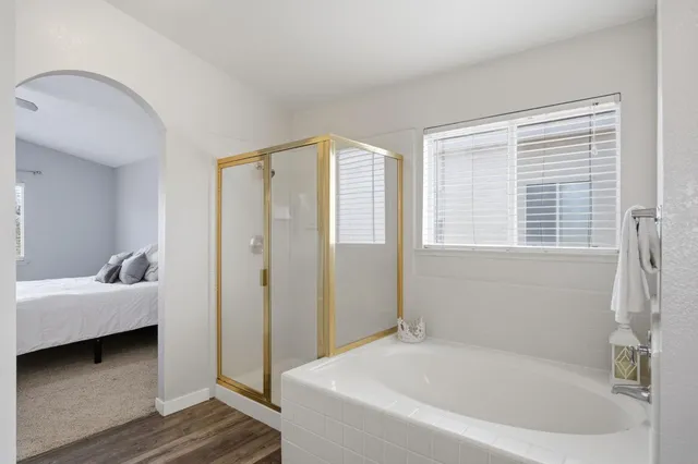 a bathroom with a bathtub and a window