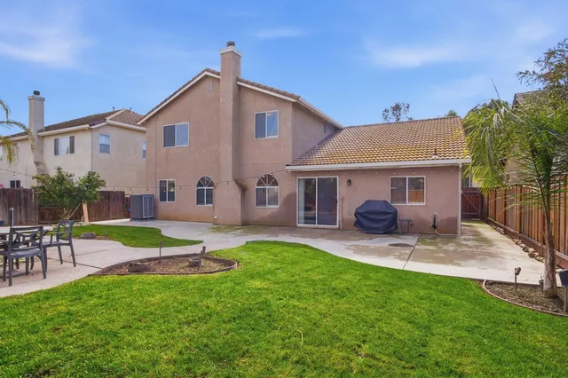 a view of a house with a yard and sitting area