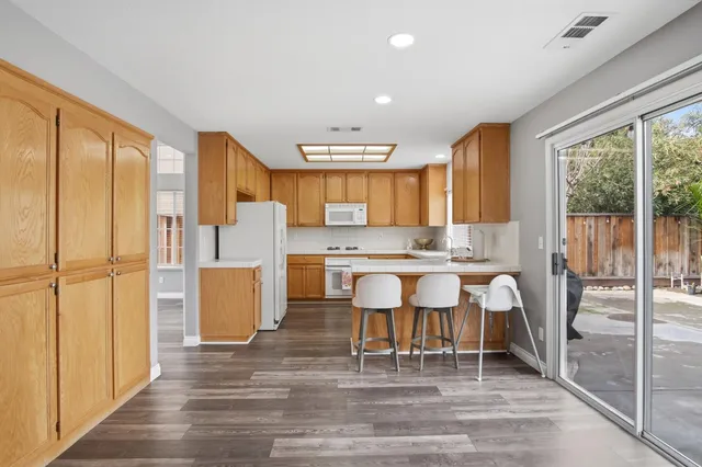 a large kitchen with a table and chairs