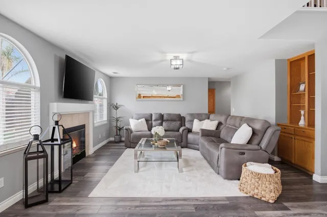 a living room with fireplace furniture and a flat screen tv