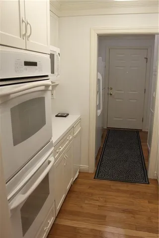 a view of a kitchen with stove and cabinets