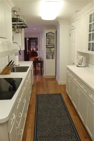 a kitchen with a sink and a stove top oven