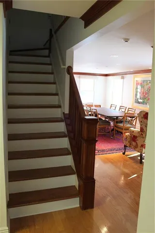 a view of entryway and hall with wooden floor