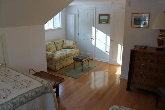 a living room with furniture and a dresser