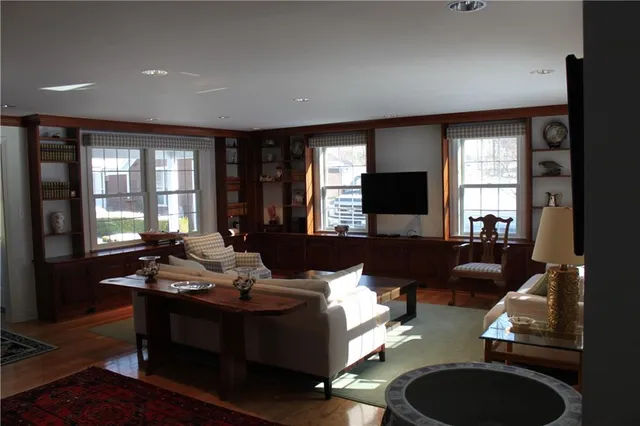 a living room with furniture window and a flat screen tv