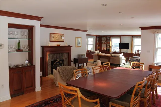 a view of a a dining room with furniture window and wooden floor