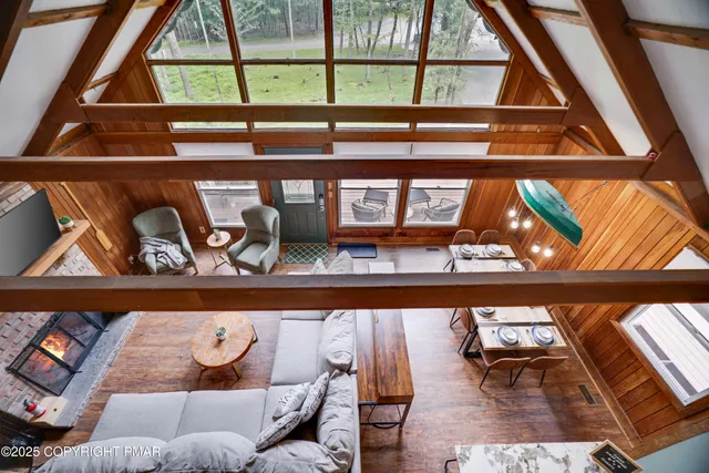 a outdoor living room with furniture and floor to ceiling windows