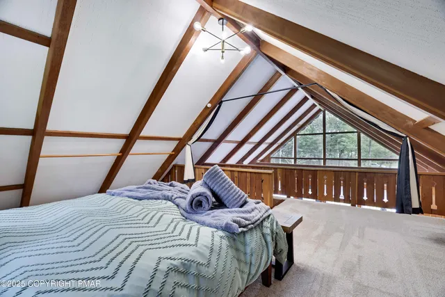 a bedroom with a bed and a large window