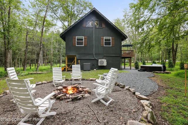 a view of backyard of house with seating space