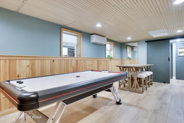 a kitchen with a table chairs and wooden floor