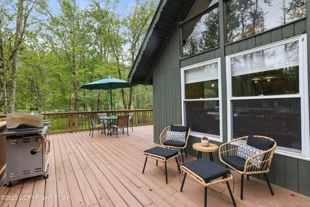 a view of a chairs and table in the balcony