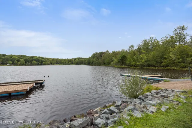 a view of a lake with houses in the back