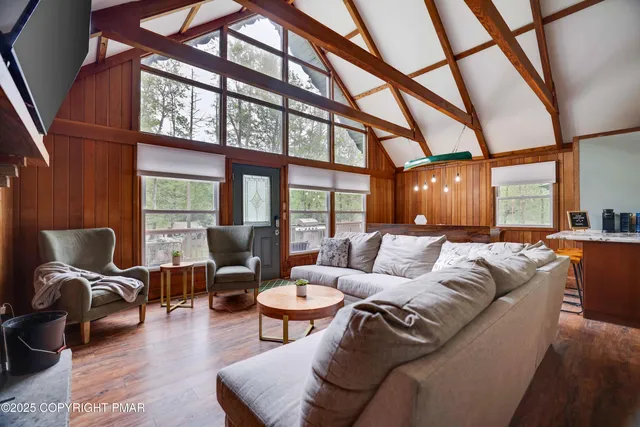 a living room with furniture and floor to ceiling windows