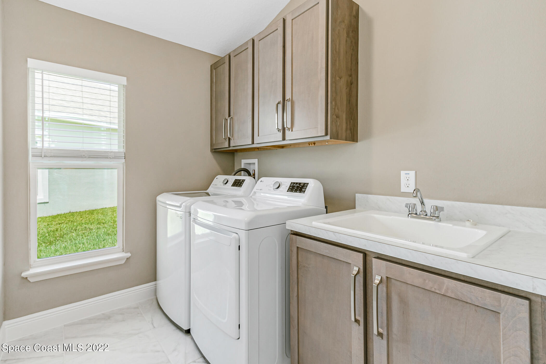 4392 Ruthann Circle Melbourne, FL 32934 - Photo 23 of 36 Laundry room w/ sink & storage