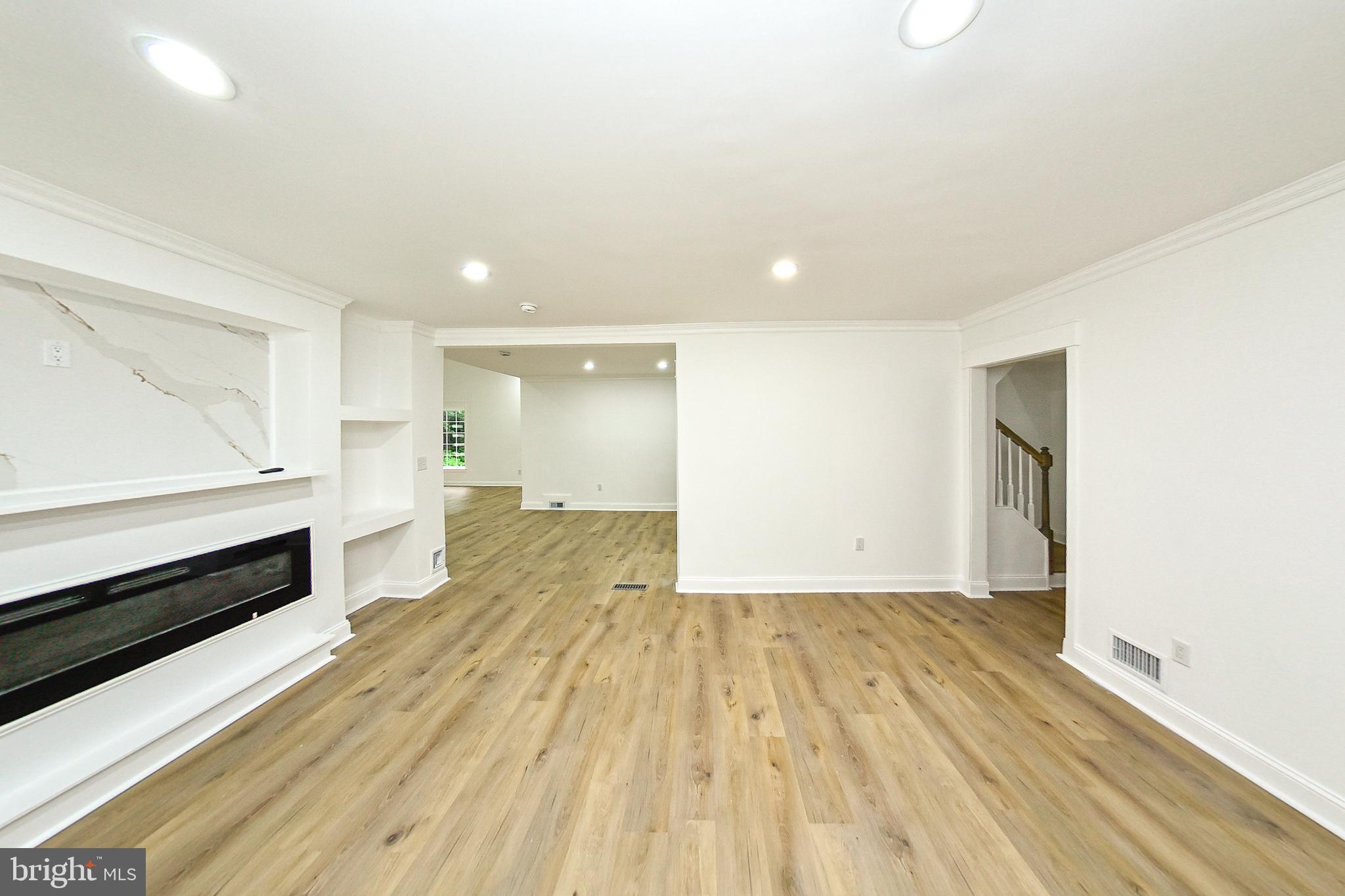 3704 Suitland Road Southeast Washington, DC 20020 - Photo 21 of 70 a view of empty room with wooden floor and fireplace
