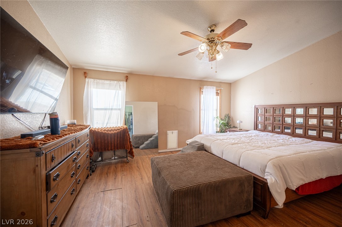 3200 Maple Road Pahrump, NV 89048 - Photo 33 of 53 Hardwood flooring extends throughout this naturally illuminated primary bedroom, offering comfort and convenience.