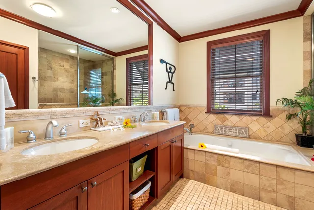 a bath room with a sink and a large mirror next to a window